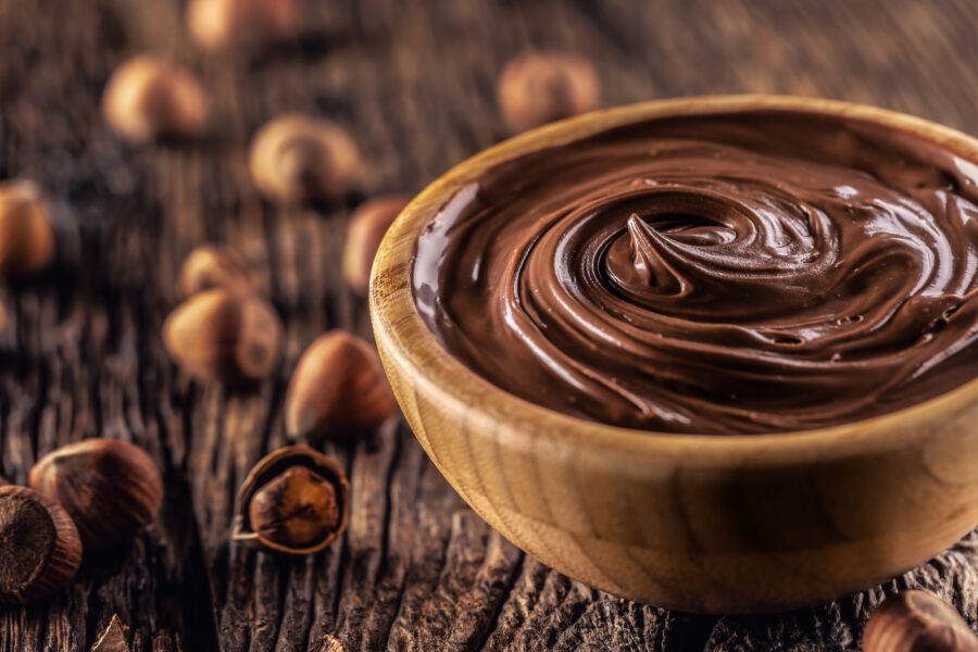 Chocolate hazelnut spread in wooden bowl - Close up. GettyImages